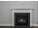 Modern gas fireplace with white mantel and dark stone surround at 131 E Northstone Rd, Mooresville, NC 28115