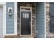 Black front door with glass panels and stone surround at 131 E Northstone Rd, Mooresville, NC 28115