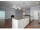 Modern kitchen with granite countertops, stainless steel appliances, and white cabinetry at 131 E Northstone Rd, Mooresville, NC 28115