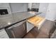 Modern kitchen island with built-in utensil organizer and dishwasher at 131 E Northstone Rd, Mooresville, NC 28115