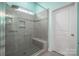 Large walk-in shower with grey tile and built-in seat at 131 E Northstone Rd, Mooresville, NC 28115