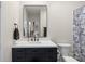 Clean bathroom, featuring a dark vanity, white countertop and a large mirror at 1315 East Blvd # 203, Charlotte, NC 28203