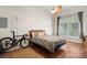 Bedroom featuring wood floors, large window, and ceiling fan at 1315 East Blvd # 203, Charlotte, NC 28203