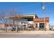 Exterior view of Cowbell Burger & Whiskey Bar, showcasing a spacious patio and industrial-chic design at 1326 Gleason Way, Charlotte, NC 28217