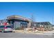 Exterior view of Cru Food & Wine Bar, featuring a modern design and outdoor seating at 1326 Gleason Way, Charlotte, NC 28217