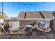 Private rooftop deck with seating area and string lights at 1326 Gleason Way, Charlotte, NC 28217