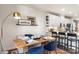 Modern dining area with a wooden table, blue velvet chairs, and a built in bench at 1326 Gleason Way, Charlotte, NC 28217