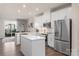 Modern kitchen with white cabinets, stainless steel appliances, and an island at 1326 Gleason Way, Charlotte, NC 28217