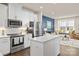 Modern kitchen with stainless steel appliances and a view into the living room at 1326 Gleason Way, Charlotte, NC 28217