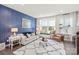 Bright living room features stylish furniture, window seat, and blue accent wall at 1326 Gleason Way, Charlotte, NC 28217