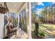 Covered back porch overlooking a spacious backyard and wooded area at 137 Deer Run Dr, Troutman, NC 28166