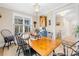 Bright dining room features a rustic wooden table with black chairs and plantation shutters at 137 Deer Run Dr, Troutman, NC 28166