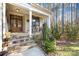 Stone steps leading to a charming front porch with wooden double doors at 137 Deer Run Dr, Troutman, NC 28166