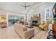 Open living room with vaulted ceiling, fireplace, and access to a screened porch at 137 Deer Run Dr, Troutman, NC 28166