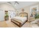 Relaxing main bedroom with a king-size bed and sliding barn door to the bathroom at 137 Deer Run Dr, Troutman, NC 28166