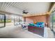 Relaxing sunroom with sectional sofa, ping pong table, and brick feature wall at 1542 Colony Rd, Rock Hill, SC 29730