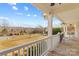 Front porch with white railings and rocking chairs, overlooking a yard at 160 Pampas Ln, Mooresville, NC 28117