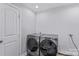 Bright laundry room, featuring a washer and dryer, and built-in shelving at 160 Pampas Ln, Mooresville, NC 28117