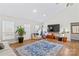 Living room with vaulted ceiling, hardwood floors, and large TV at 160 Pampas Ln, Mooresville, NC 28117