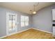 Dining area with wood-look floors and door to backyard at 16220 Circlegreen Dr, Charlotte, NC 28273