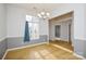 Simple dining room with light gray walls and hardwood floors at 16220 Circlegreen Dr, Charlotte, NC 28273