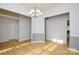 Dining room with hardwood floors, gray walls, and a chandelier at 16220 Circlegreen Dr, Charlotte, NC 28273