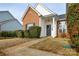 Front view of a brick and white house with a black door and walkway at 16220 Circlegreen Dr, Charlotte, NC 28273