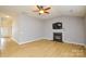 Living room with fireplace, hardwood floors, and ceiling fan at 16220 Circlegreen Dr, Charlotte, NC 28273