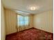 Bedroom with patterned wallpaper and carpet at 1824 N Charlotte Ave, Monroe, NC 28110