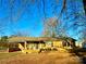 Ranch style brick home with carport and mature trees at 1824 N Charlotte Ave, Monroe, NC 28110