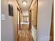 Long hallway with light colored walls and wood flooring at 1824 N Charlotte Ave, Monroe, NC 28110