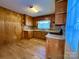 Wood cabinets, laminate counters, and a view into the dining area at 1824 N Charlotte Ave, Monroe, NC 28110