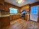 Galley kitchen with wood cabinets and stainless steel appliances at 1824 N Charlotte Ave, Monroe, NC 28110