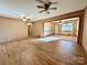 Spacious living room with hardwood floors and ceiling fans at 1824 N Charlotte Ave, Monroe, NC 28110