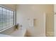 Relaxing bathroom featuring a bathtub, shower, and a window at 2003 Galty Ln, Charlotte, NC 28270