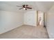 Bedroom with ceiling fan, carpet, and access to bathroom at 2003 Galty Ln, Charlotte, NC 28270