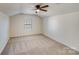 Simple bedroom with ceiling fan and carpet flooring at 2003 Galty Ln, Charlotte, NC 28270