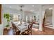 Elegant dining room with hardwood floors, chandelier, and stained glass window at 2003 Galty Ln, Charlotte, NC 28270