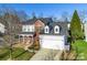 Two-story house with a brick facade, attached garage, and manicured lawn at 2003 Galty Ln, Charlotte, NC 28270