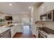 Modern kitchen with white cabinets, herringbone backsplash, and island at 2003 Galty Ln, Charlotte, NC 28270