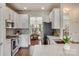 Modern kitchen with white cabinets, quartz countertops, and stainless steel appliances at 2003 Galty Ln, Charlotte, NC 28270