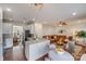 Combined kitchen and living area features a marble island and a brown leather sectional sofa at 2003 Galty Ln, Charlotte, NC 28270