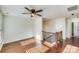 Spacious loft area with hardwood floors, windows, and ceiling fan at 2003 Galty Ln, Charlotte, NC 28270