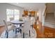 Bright dining room features a round table with seating for four and hardwood floors at 2033 Roscommon Dr, Clover, SC 29710