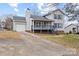 Two-story house with gray deck, attached garage, and landscaped lawn at 212 King George Ln, Gastonia, NC 28056