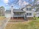 Two-story house with gray deck, attached garage, and landscaped lawn at 212 King George Ln, Gastonia, NC 28056