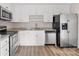 Modern kitchen with white cabinets, granite counters, and stainless steel appliances at 212 King George Ln, Gastonia, NC 28056