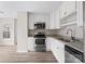 Modern kitchen with white cabinets, granite counters, and stainless steel appliances at 212 King George Ln, Gastonia, NC 28056