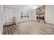 Living room with stone fireplace and laminate wood floors at 212 King George Ln, Gastonia, NC 28056