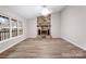 Living room featuring a stone fireplace and large windows at 212 King George Ln, Gastonia, NC 28056